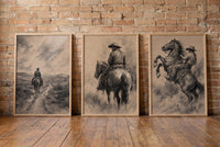 Charcoal Riders framed prints leaning against a brick wall