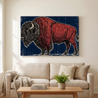 Woodcut Bison – American bison as a red and black relief print on deep blue, patriotic canvas wall art above a linen sofa in a living room