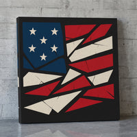 Shattered Liberty – American flag broken into angular shards, patriotic canvas wall art leaning against a concrete wall
