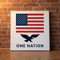 One Nation – American flag above a navy eagle and One Nation lettering, patriotic canvas wall art leaning against a red brick wall
