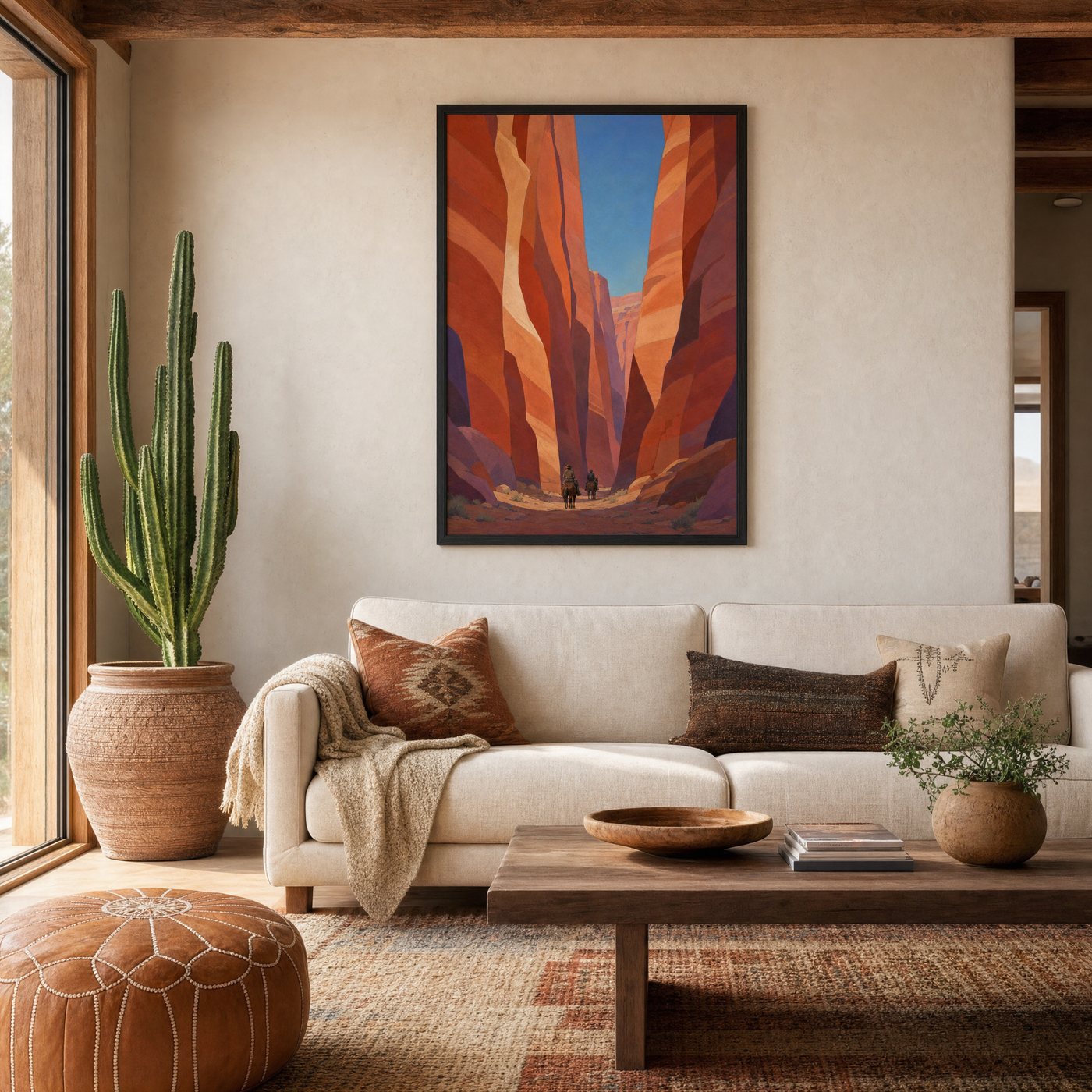 Canyon Riders framed print, 24x36 inch, shown above a sofa in a warm southwestern living room.
