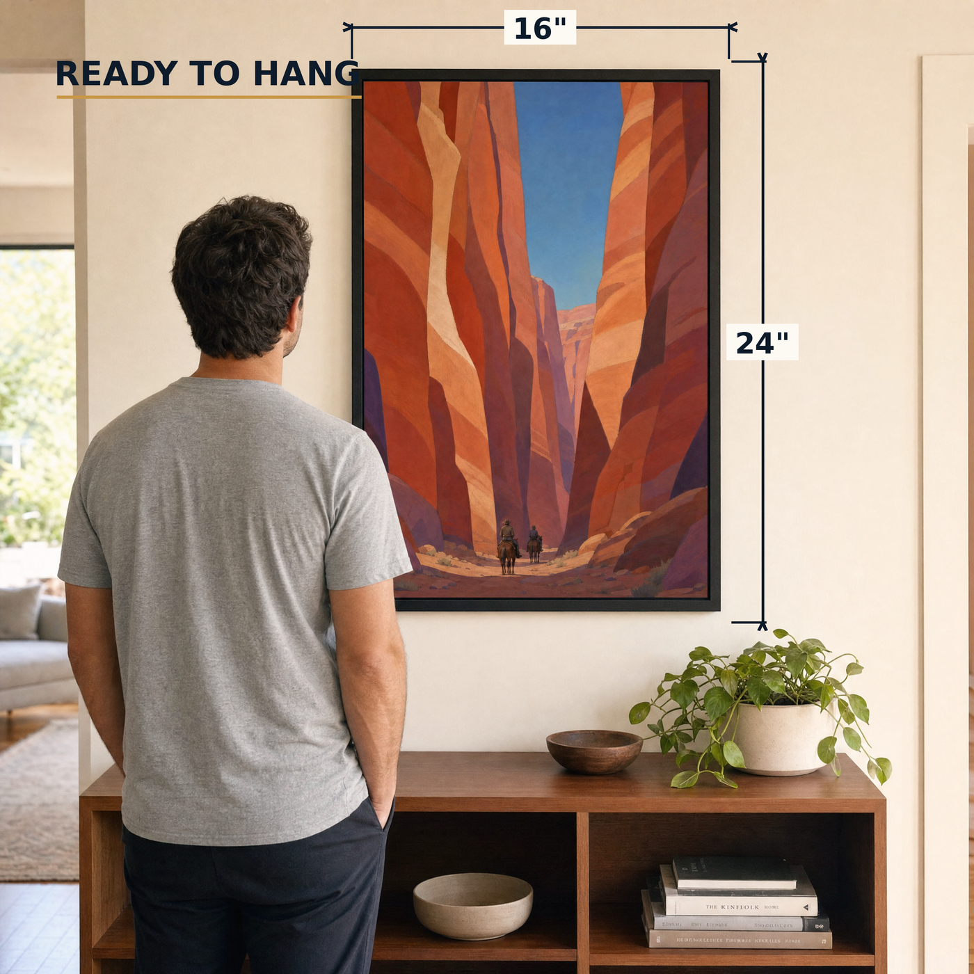 Canyon Riders framed print, 16x24 inch, shown beside a man for scale — ready to hang out of the box.