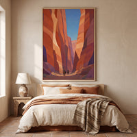 Canyon Riders framed print in a light wood frame above a bed in a warm southwestern bedroom