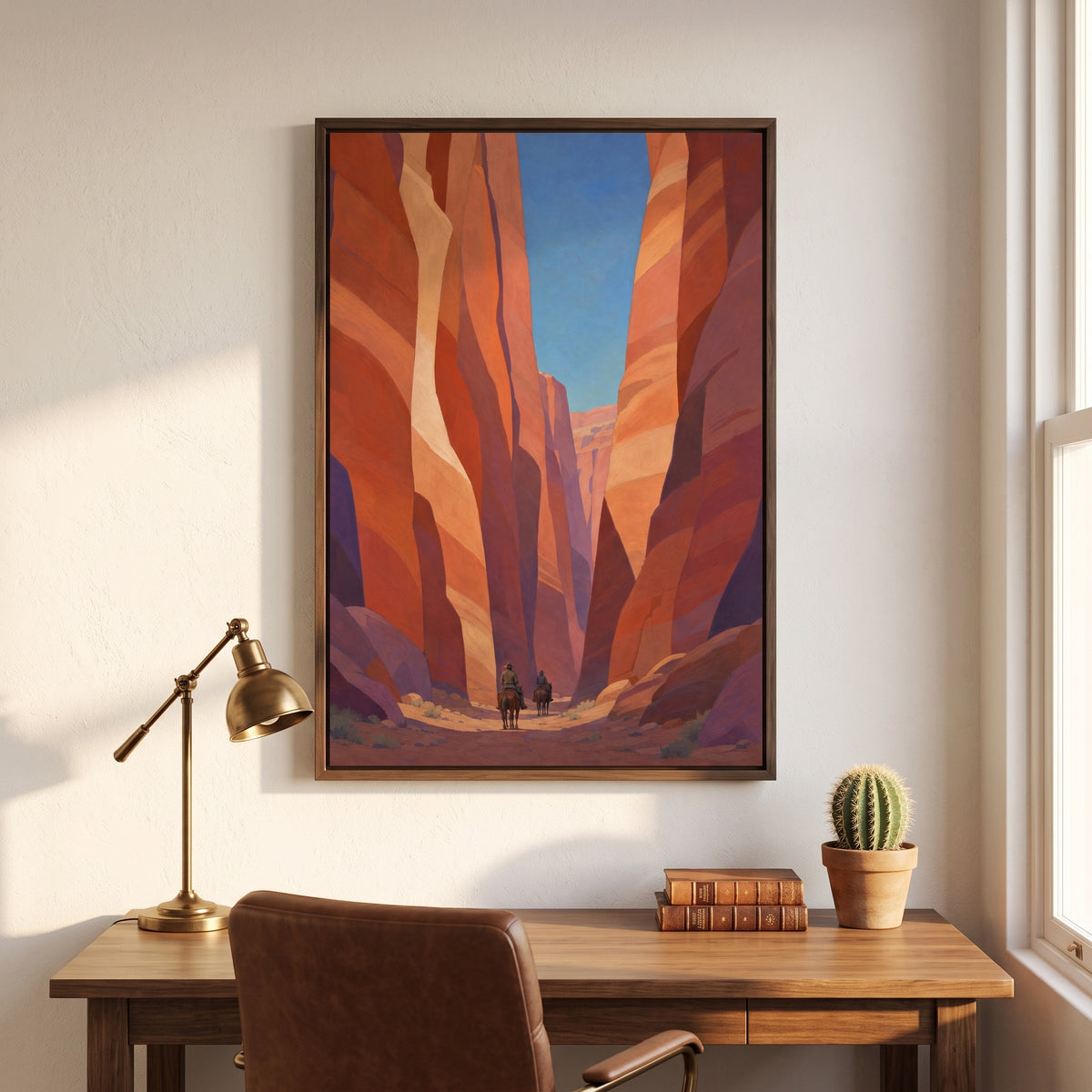 Canyon Riders framed print in a dark wood frame above a writing desk in a home study