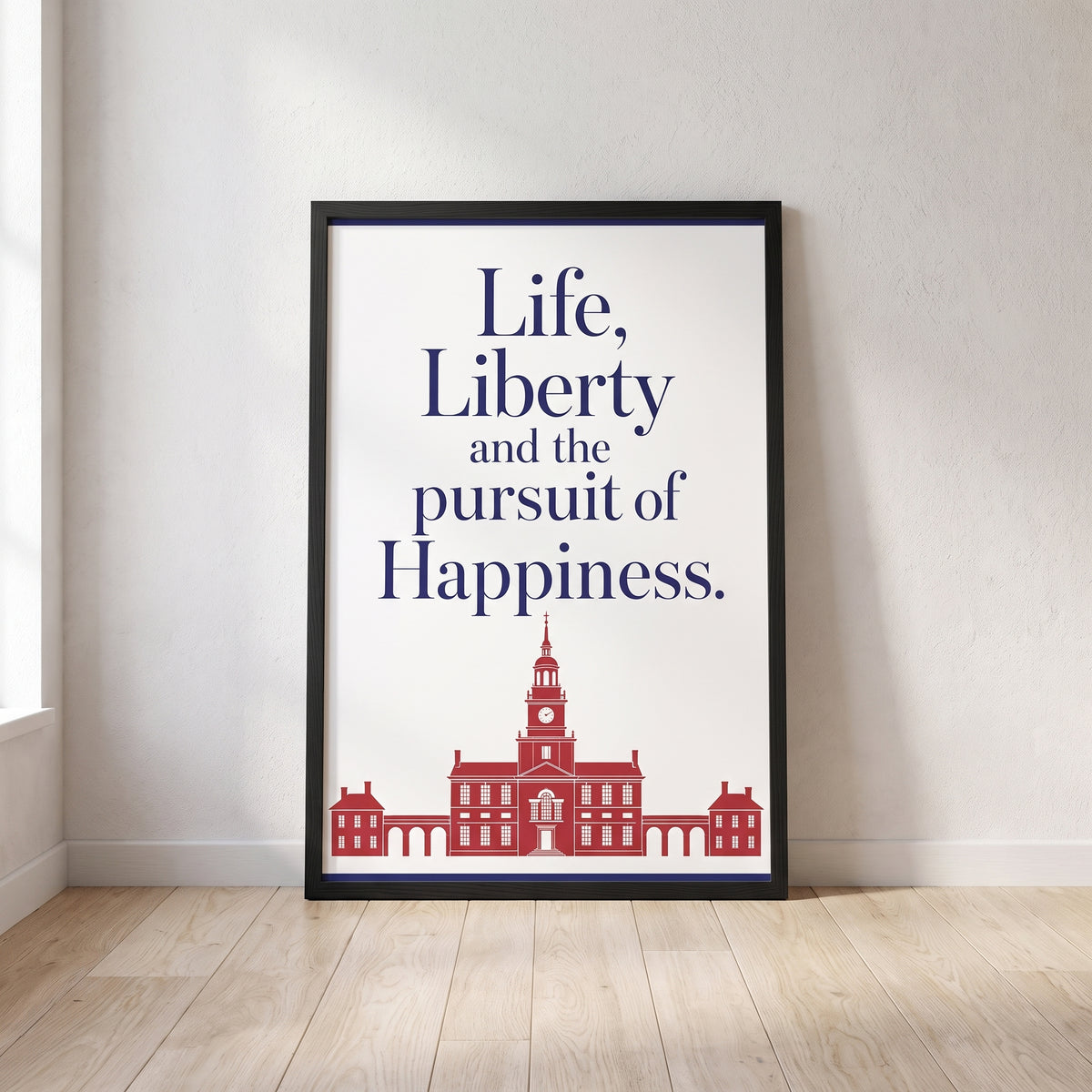 Life, Liberty & the Pursuit of Happiness framed print leaning against a wall