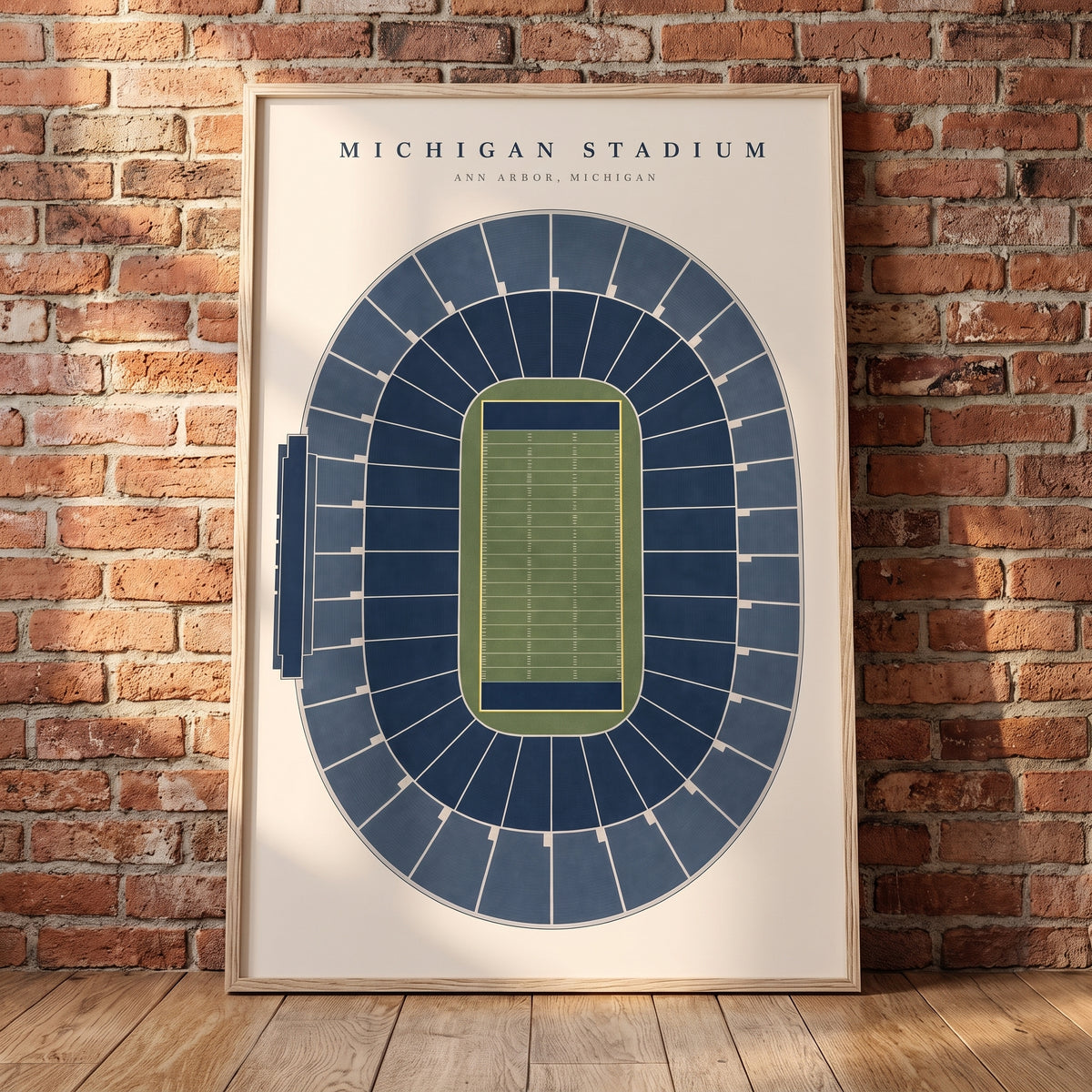 Michigan Stadium framed print leaning against a wall
