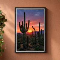 Desert Gold framed print, matte black frame, shown on a warm terracotta wall — ready to hang.