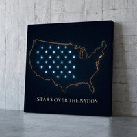 Stars over the Nation – gold outline map of the United States with blue stars on navy, patriotic canvas wall art leaning against a concrete wall