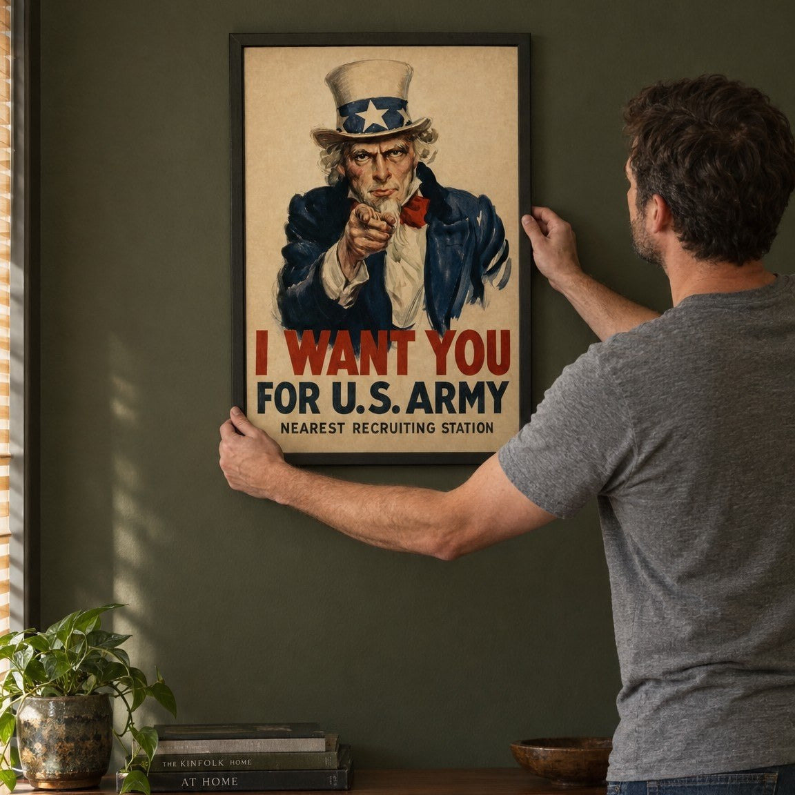 Man hanging the I Want You framed print on the wall