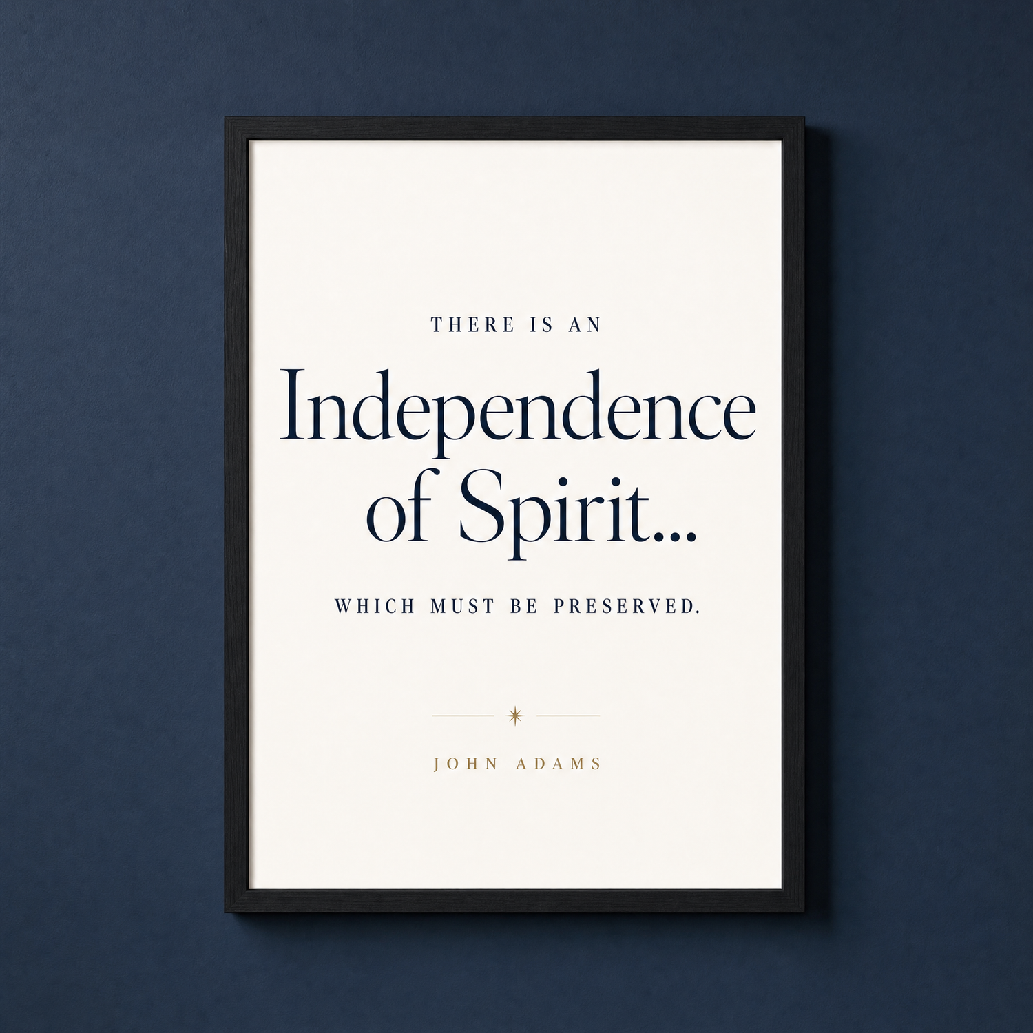 Independence quote print in a slim matte black frame on a deep navy wall — a John Adams line in dignified type, ready to hang.