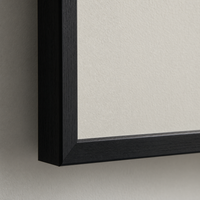 Close-up of the matte museum fine-art paper surface and the slim black frame edge.