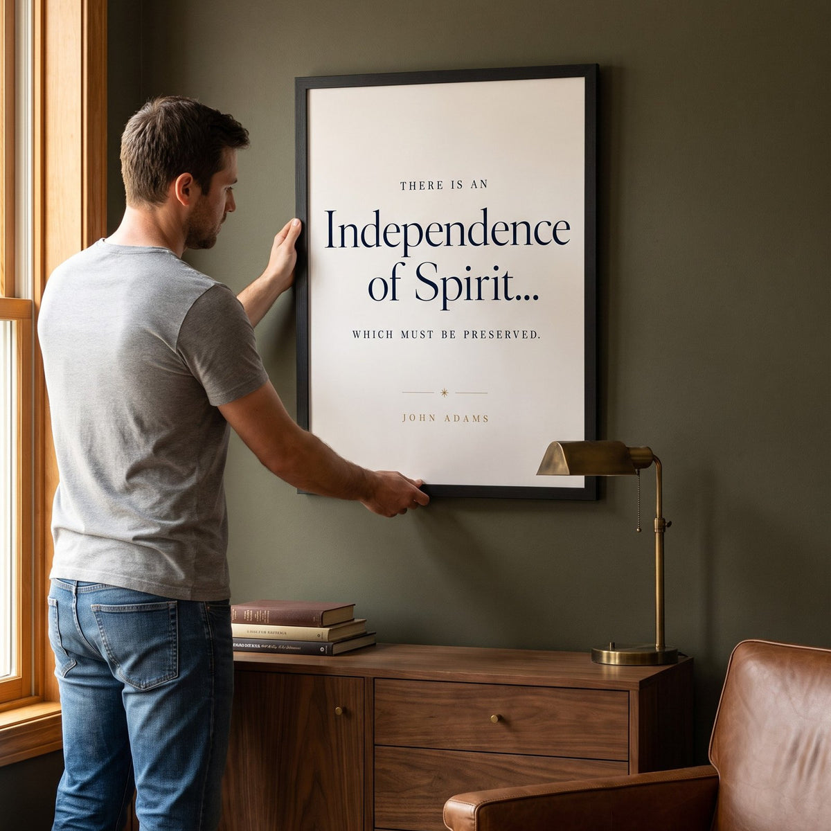 Man hanging the Independence framed print on the wall
