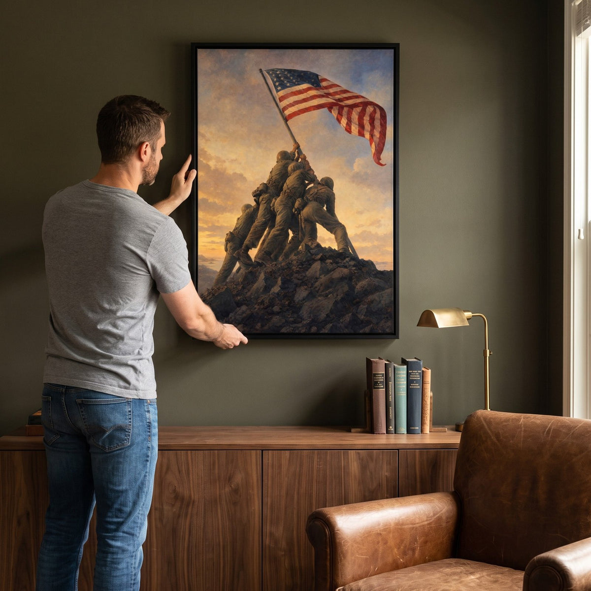 Man hanging the Raising the Flag on Iwo Jima framed print on the wall