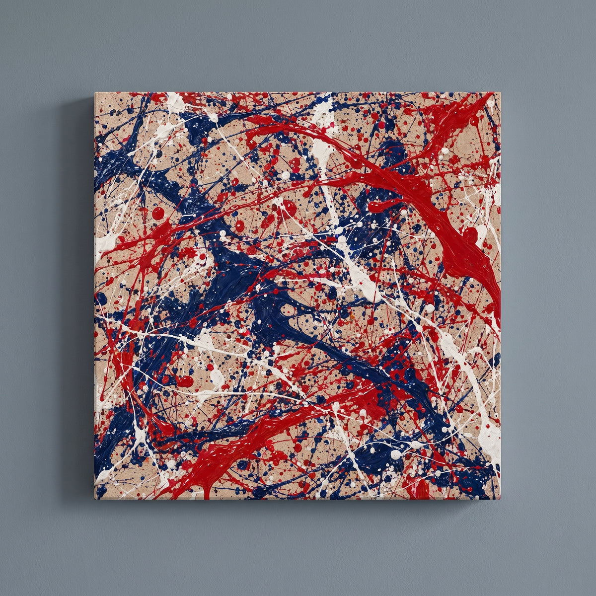Poured Colors – red, white and blue paint poured and flung across raw linen, patriotic canvas wall art on a slate grey wall