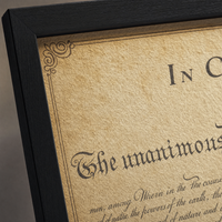 Close-up of the aged parchment print surface with its decorative border on matte museum fine-art paper.