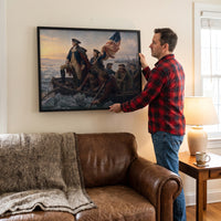 Man hanging the Washington Crossing the Delaware framed print on the wall