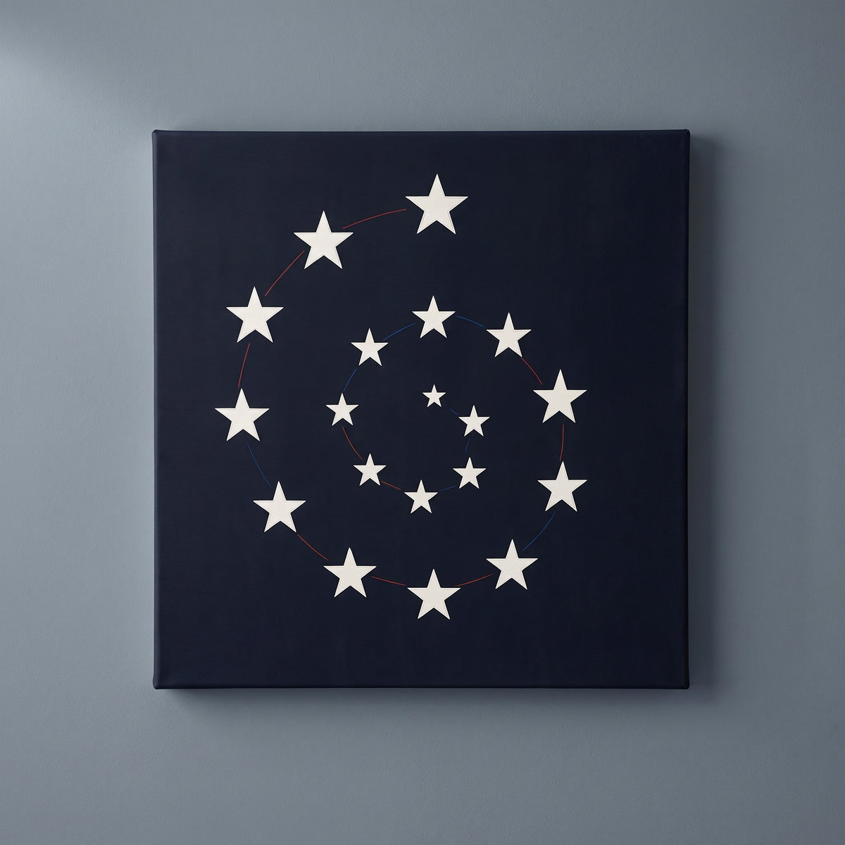 Vortex of America – white stars spiraling on a black ground, patriotic canvas wall art on a slate grey wall