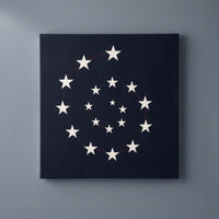 Vortex of America – white stars spiraling on a black ground, patriotic canvas wall art on a slate grey wall